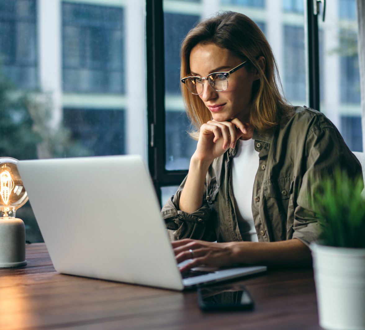 a woman sitting at a desk with a laptop